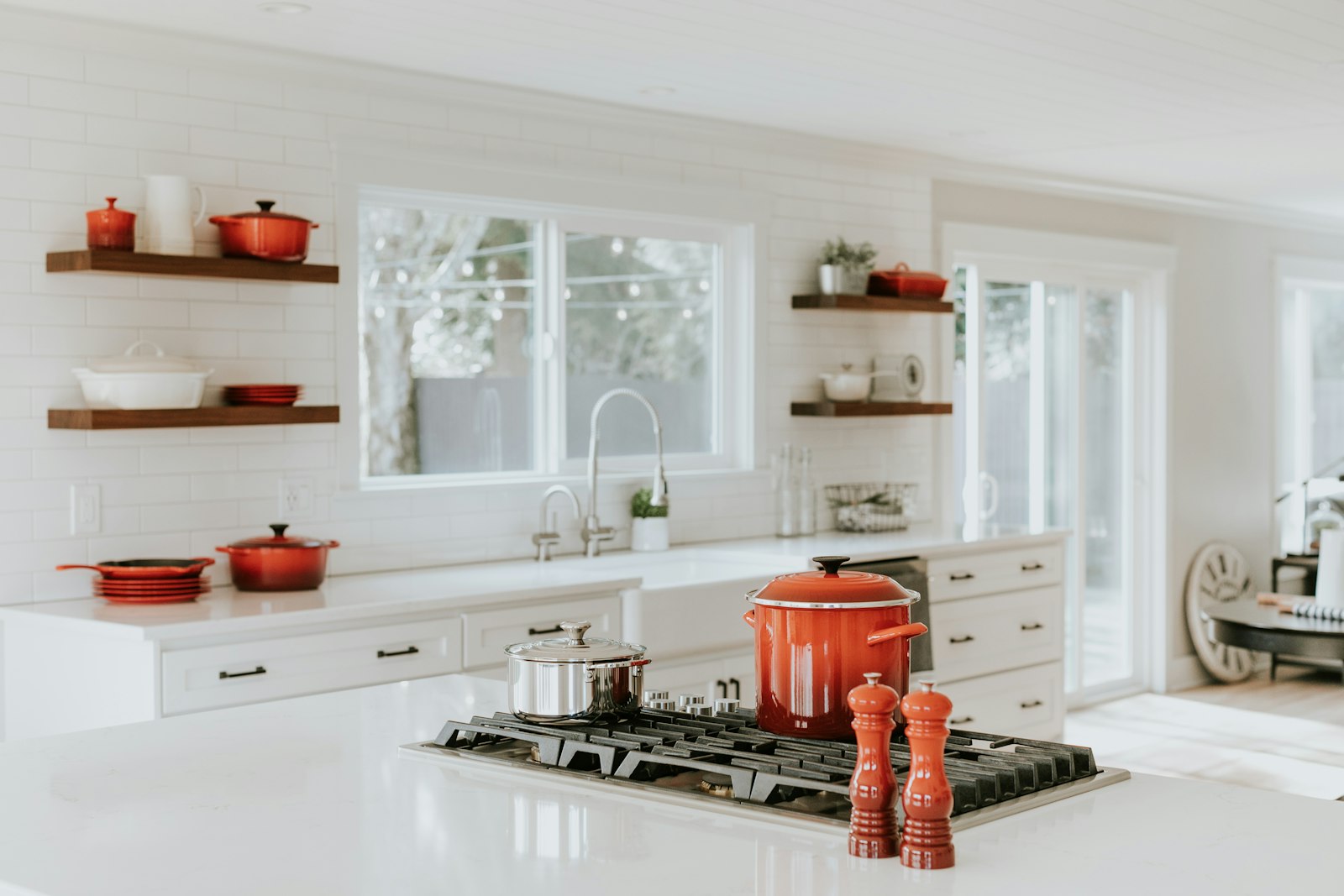 Remodeled residential kitchen with island cooktop and open shelving