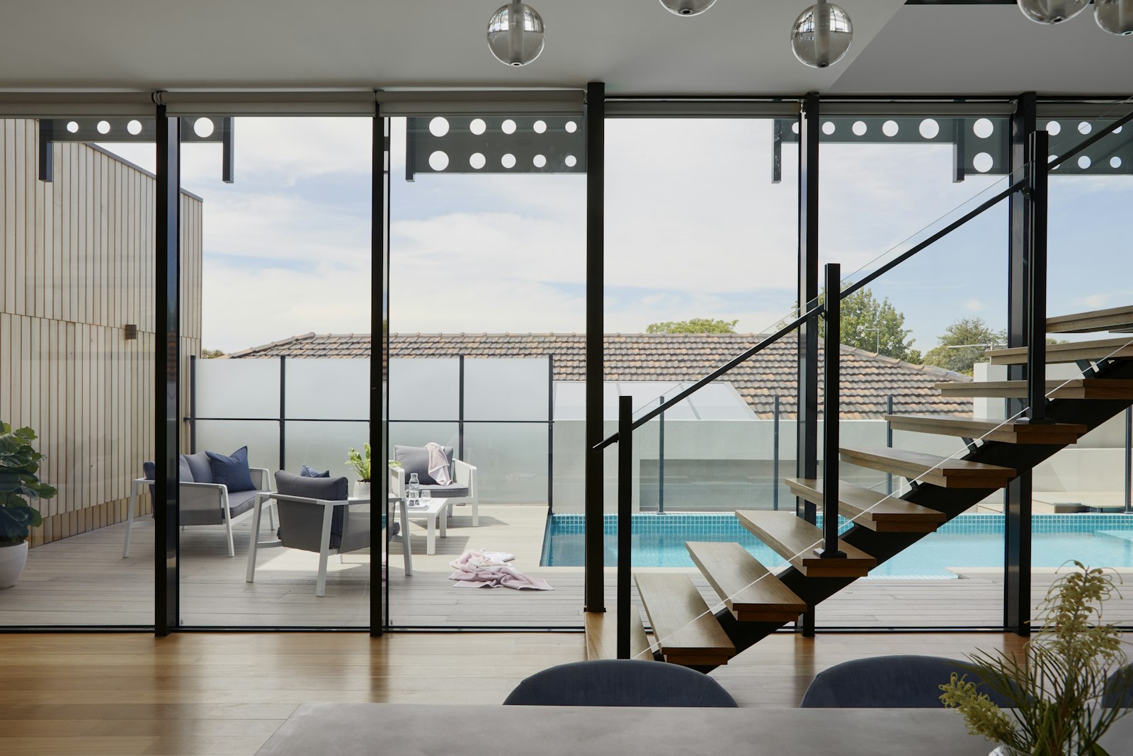Backyard pool and covered patio off a residential living room